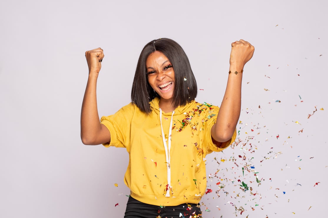 African Lady Celebrates with Confetti Sprayed